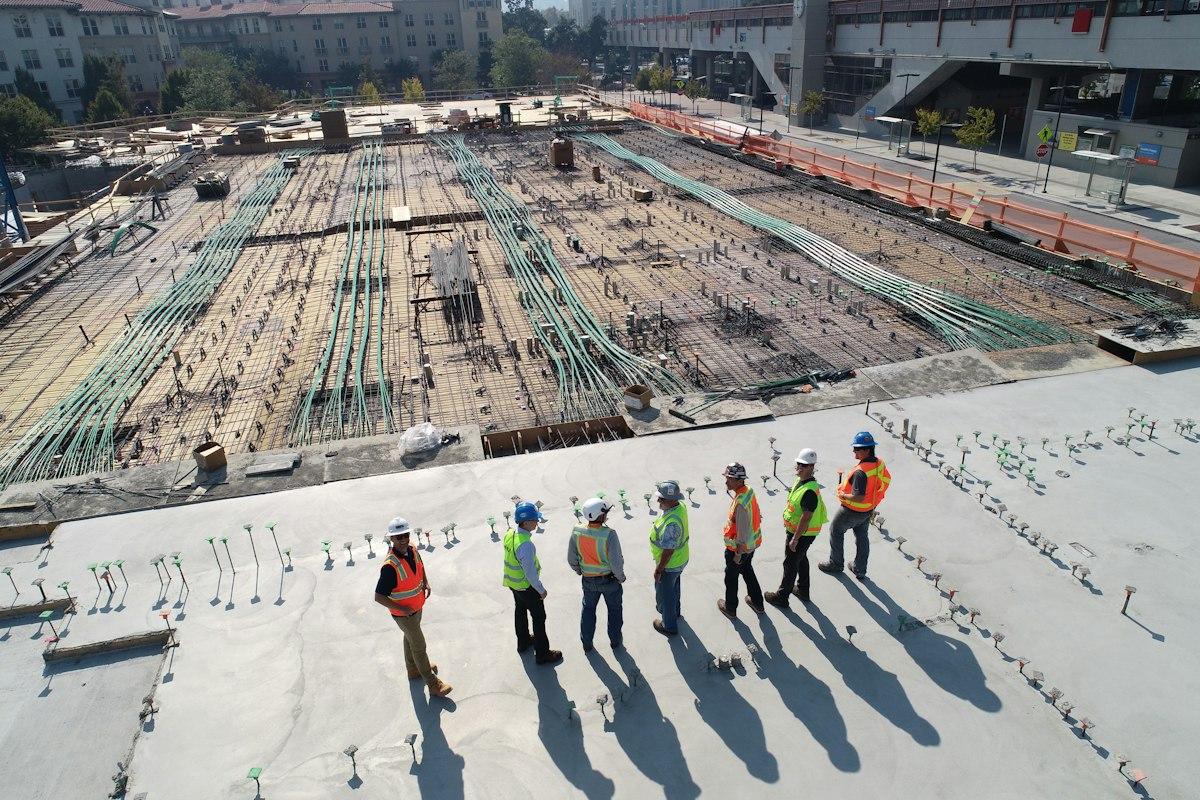 Engineer taking measurements from a construction drawing